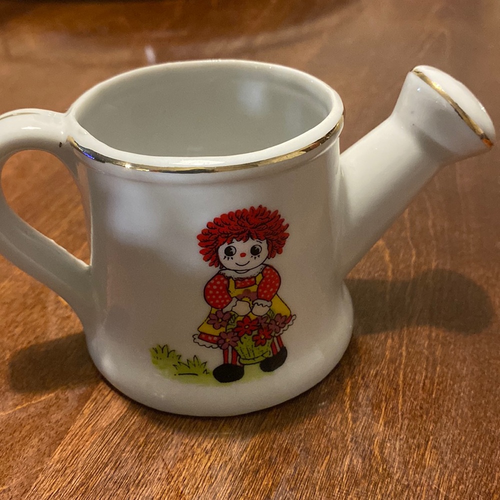 Vintage raggedy Ann ceramic watering can.